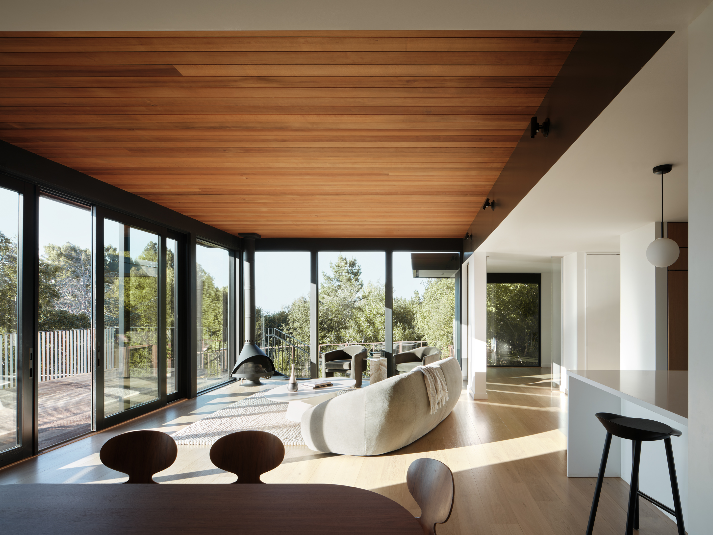 Hilltop Residence by Michael Hennessey Architecture, a modernist inspired home, low lying and linear with timber ceilings and black accents