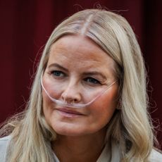 Queen Mette Marit wearing a nasal cannula