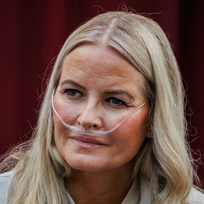 Queen Mette Marit wearing a nasal cannula