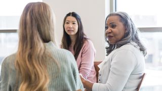 Women together in a group taking part in group therapy and CBT for menopause