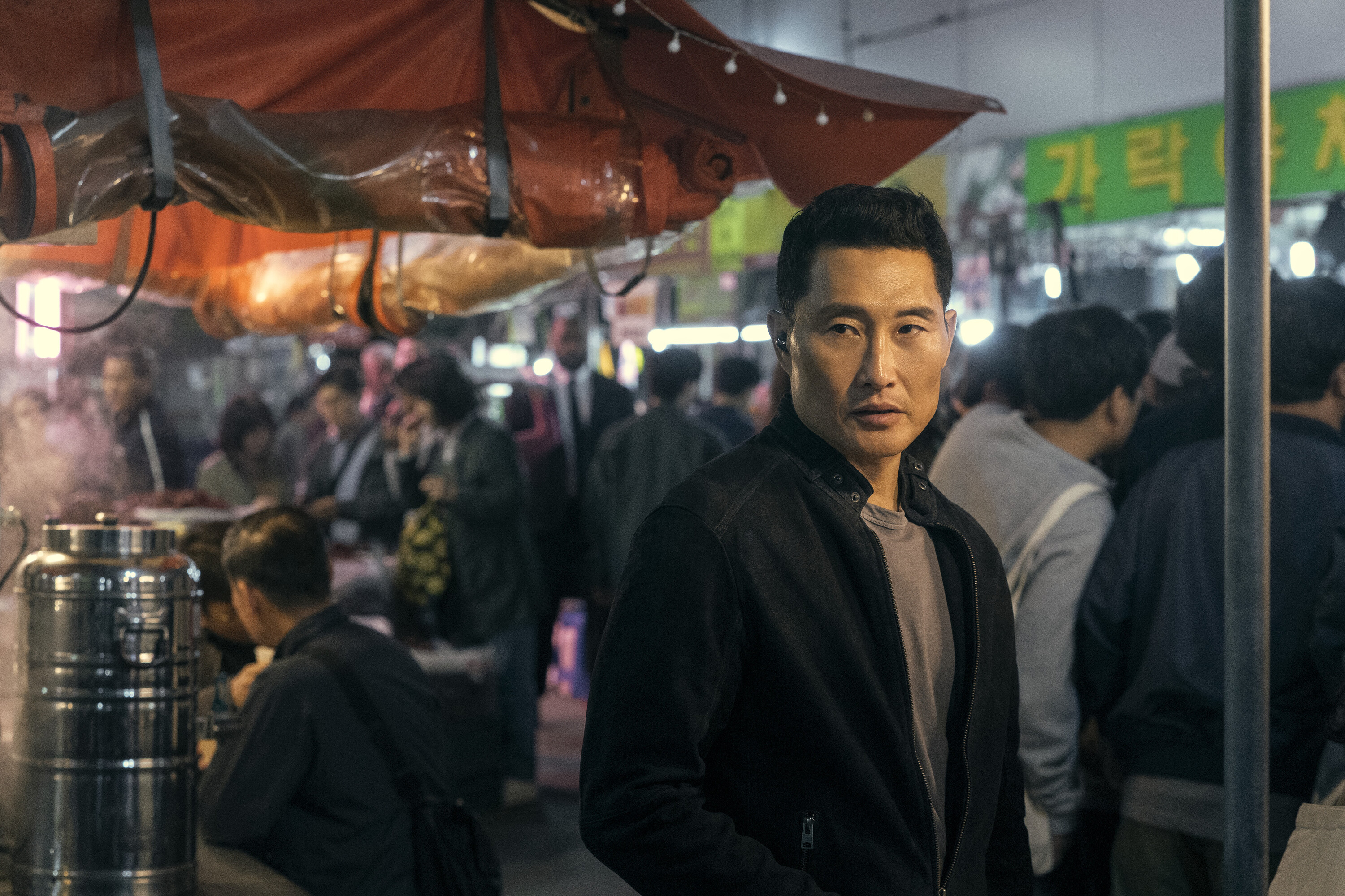 Daniel Dae Kim as David, standing in a busy city street in Korea, in 'Butterfly' on Prime Video.