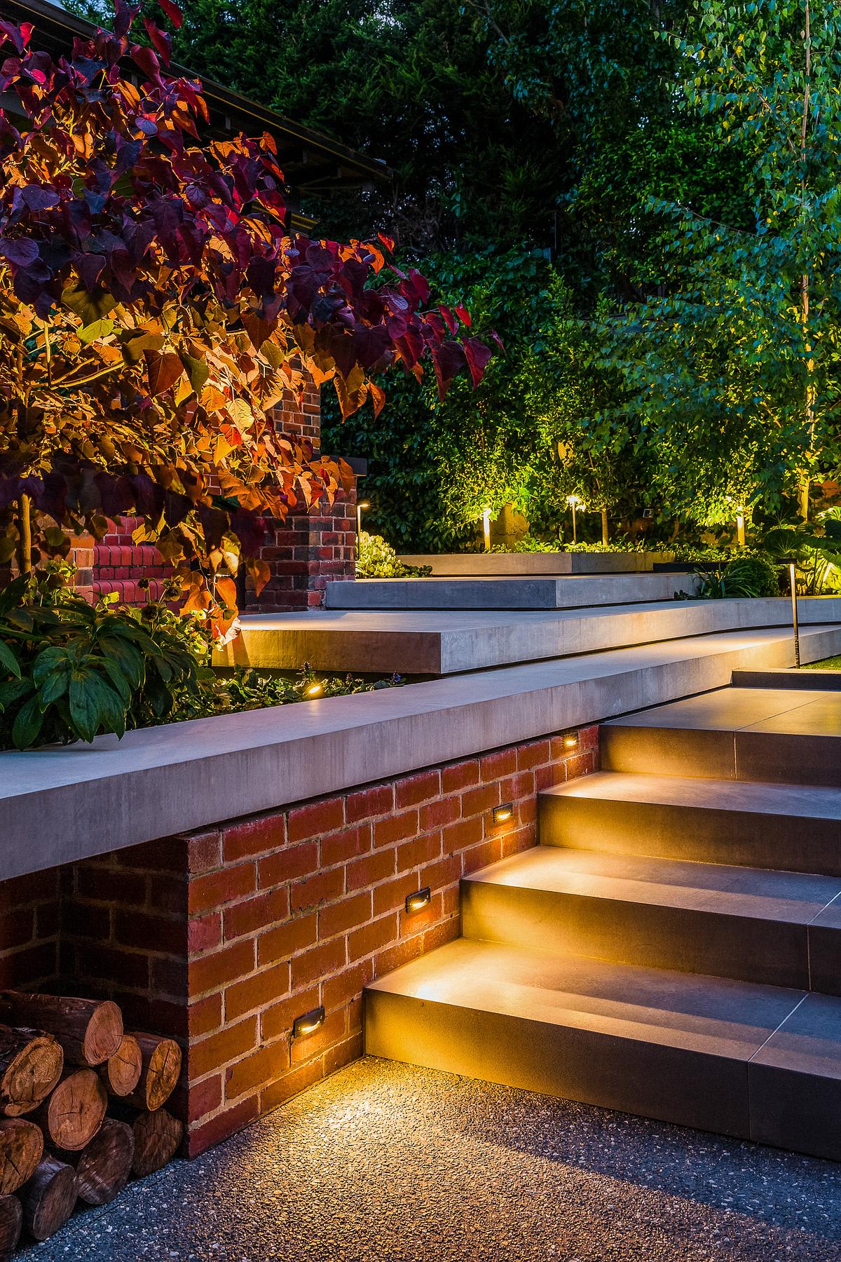 A garden with well-lit garden steps