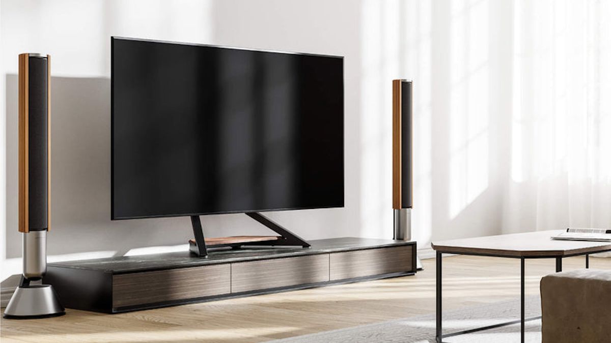 The Fitueyes Eiffel TV stand pictured holding a large TV in an upmarket living room