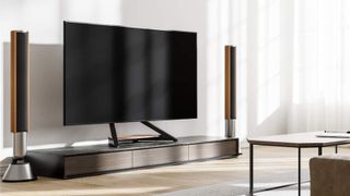 The Fitueyes Eiffel TV stand pictured holding a large TV in an upmarket living room