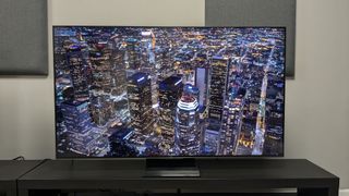 TCL C805 with aerial shot of city at night on screen