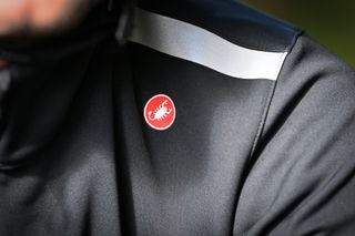 Close-up of the shoulder of the Castelli Espresso Air Jacket showing the reflective patch and Castelli logo