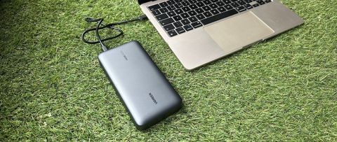 UGreen 145W power bank on grass with a MacBook Air