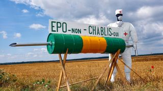 A model is displayed on the side of the road standing by a huge syringe denouncing doping during the fifth stage of the 94th Tour de France cycling race between Chablis and Autun, 12 July 2007. The syringe reads "EPO, no / Chablis, yes". Chablis is a famous white wine coming from Burgundy region. AFP PHOTO / JOEL SAGET (Photo credit should read JOEL SAGET/AFP via Getty Images)