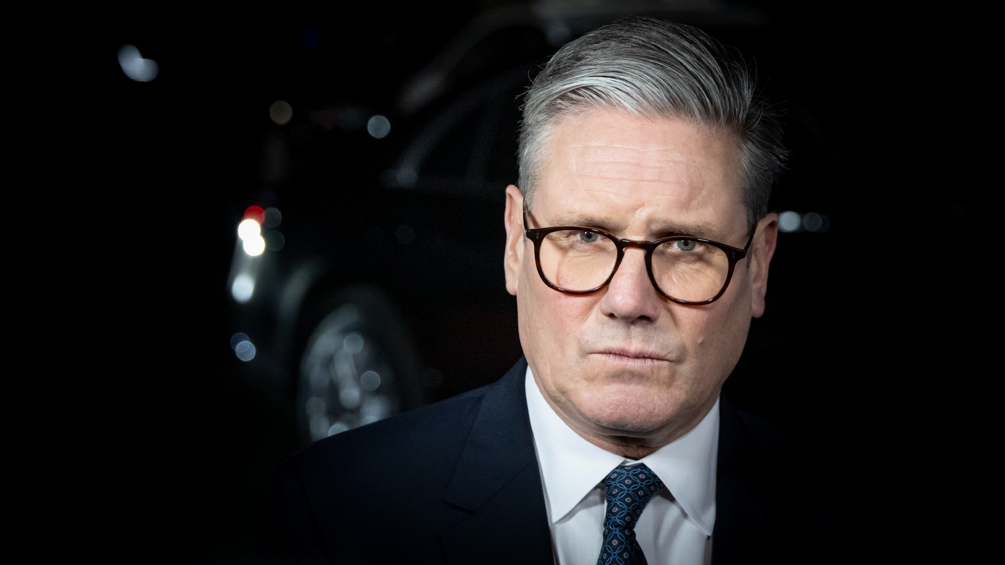 Keir Starmer, against a dark backdrop