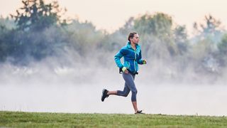Woman running in outdoors wearing jacket