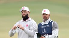 Jon Rahm and his caddie, Adam Hayes discuss a shot during the 2024 Alfred Dunhill Links Championship