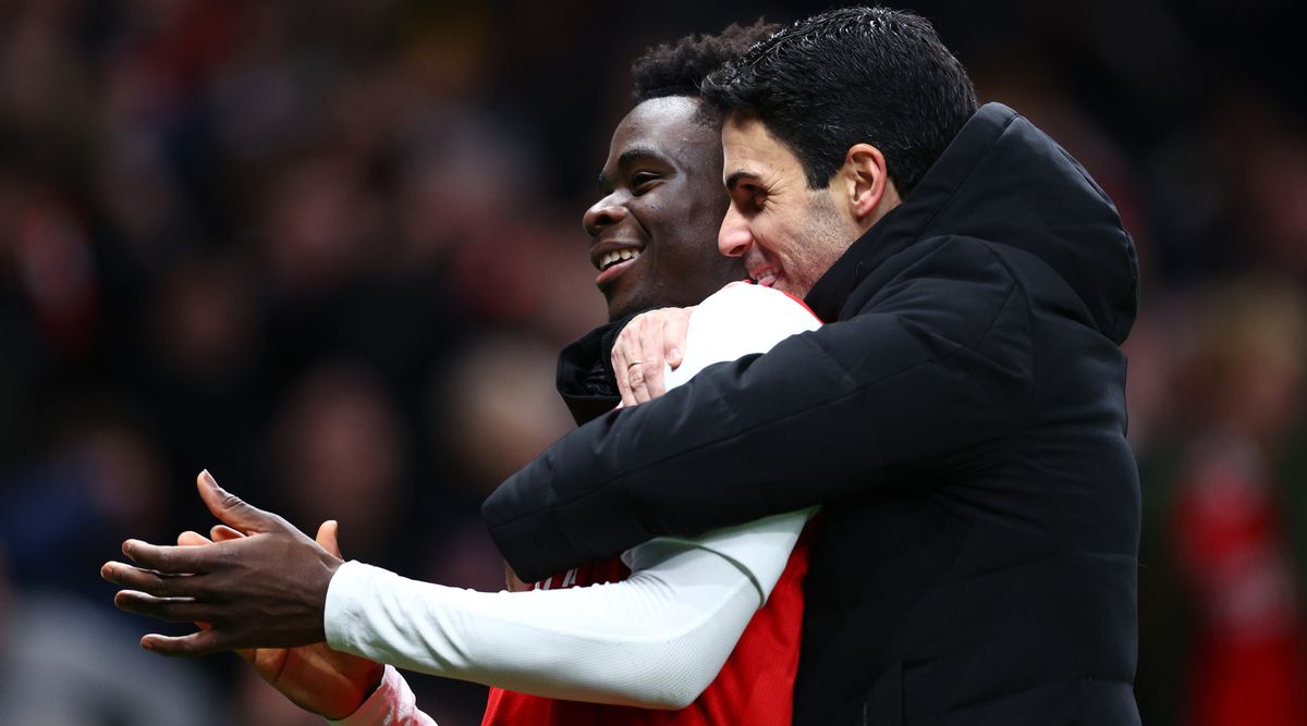 Arsenal&#039;s Bukayo Saka and manager Mikel Arteta celebrate after their team&#039;s victory in the Premier League match between Tottenham Hotspur and Arsenal on 15 January, 2023 at the Tottenham Hotspur Stadium in London, United Kingdom.