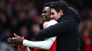 Arsenal's Bukayo Saka and manager Mikel Arteta celebrate after their team's victory in the Premier League match between Tottenham Hotspur and Arsenal on 15 January, 2023 at the Tottenham Hotspur Stadium in London, United Kingdom.