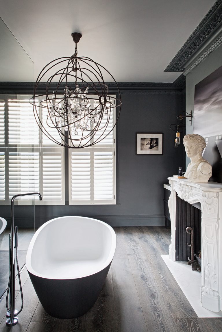 dark grey modern bathroom with statement chandelier