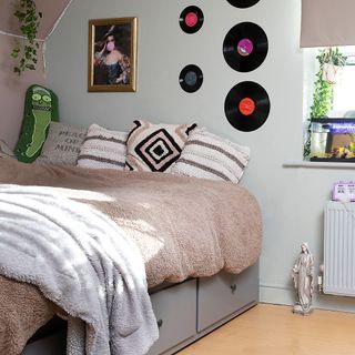 Girls bedroom with fleece bedding, cushions and vinyl records on the wall