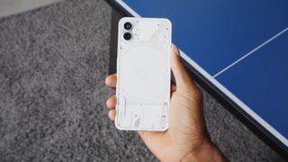 A screenshot from a hands-on video of the Nothing Phone (1), showing the phone's back