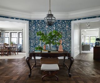circular hallway blue floral wallpaper dark furniture