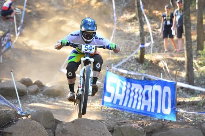 Third placed Jared Graves negotiates a rock section on his way to the bronze medal in the men's downhill final