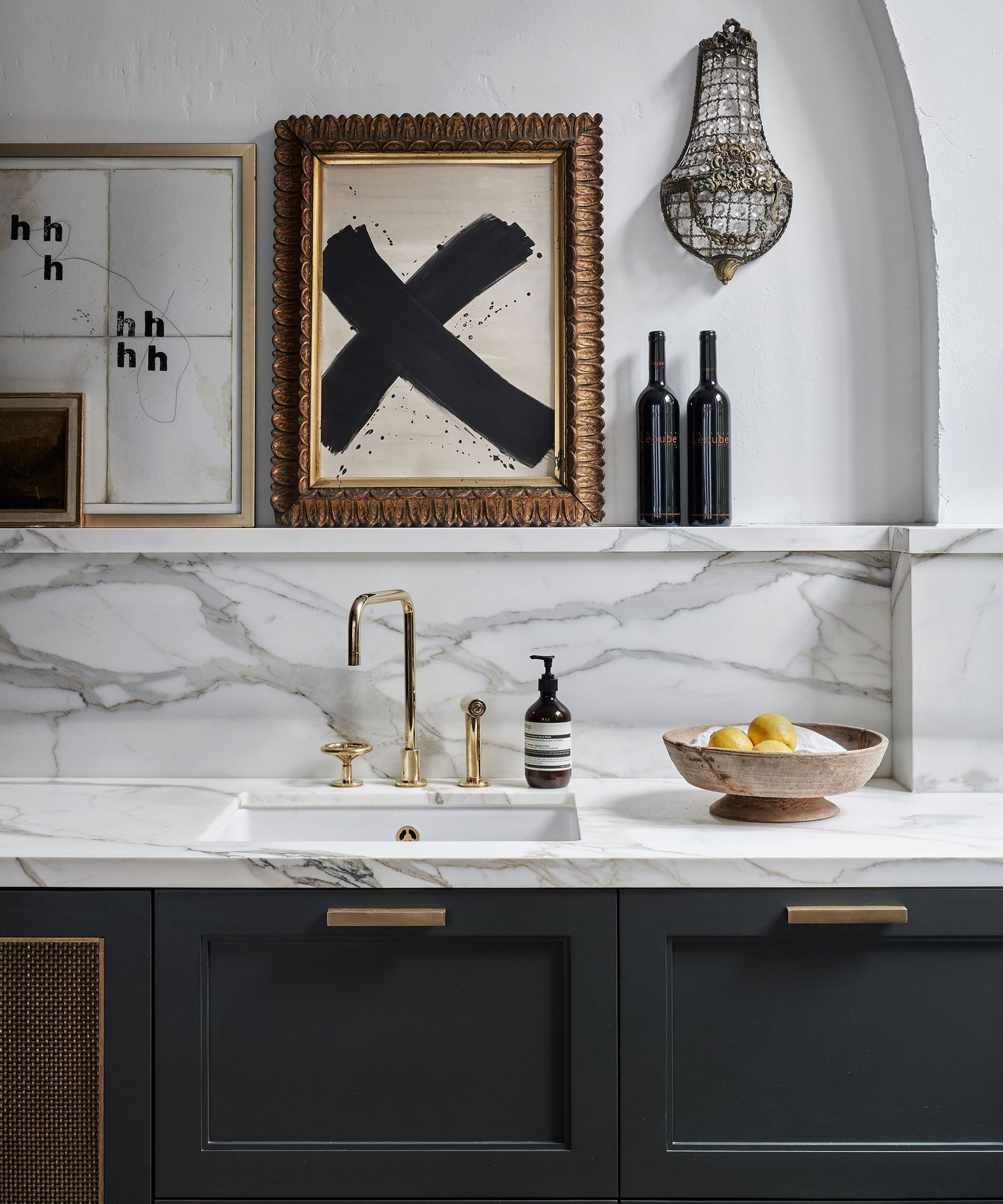Transitional kitchen with brass handles and accents