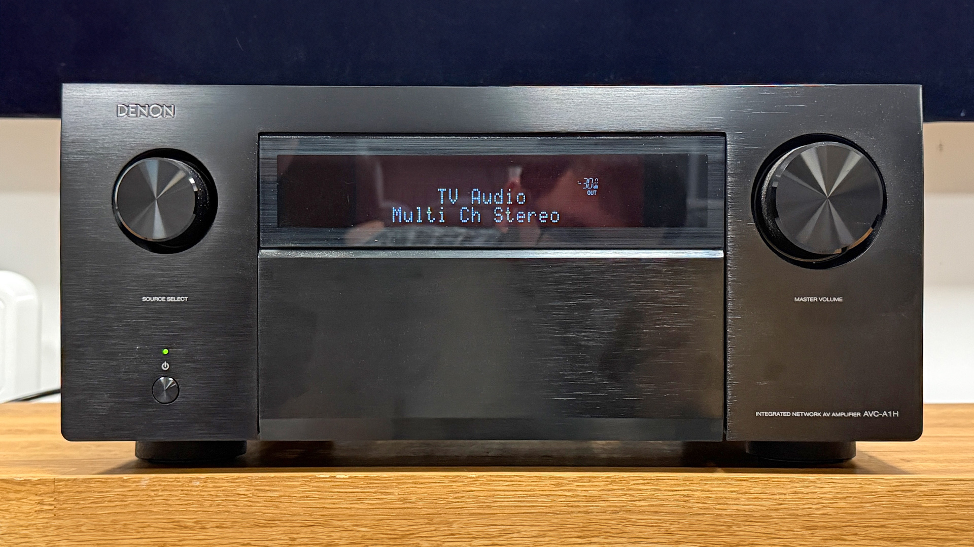 Denon AVC-A1H AV amplifier on wooden AV rack
