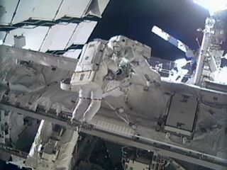 Astronauts Greg Chamitoff and Mike Fincke work on the exterior of the International Space Station during the fourth spacewalk of the STS-134 mission, May 27, 2011 (Flight Day 11).
