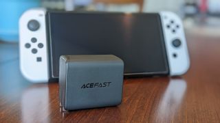Acefast PD charging hub in front of Switch OLED