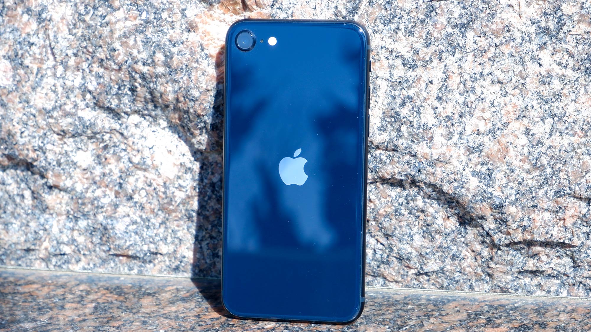 iPhone SE 2022 back of phone against stone