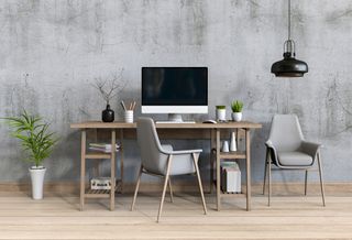 A home office set up with a desk, computer and chair