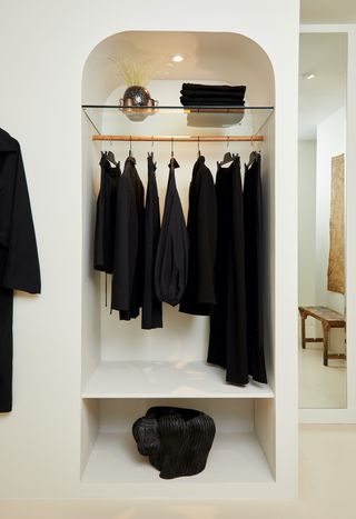 A rail on black clothes in white-walled New York boutique