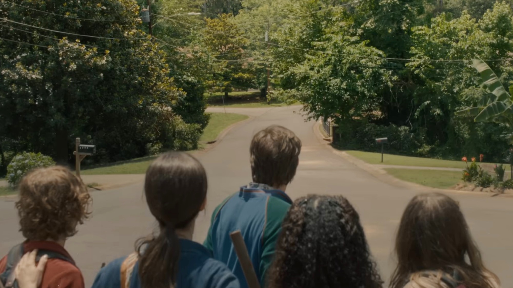 A family and friend staring at the end of the block in The End of Oak Street