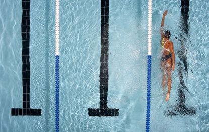 Best swimming pools in UK: A woman swimming in a lane at a pool