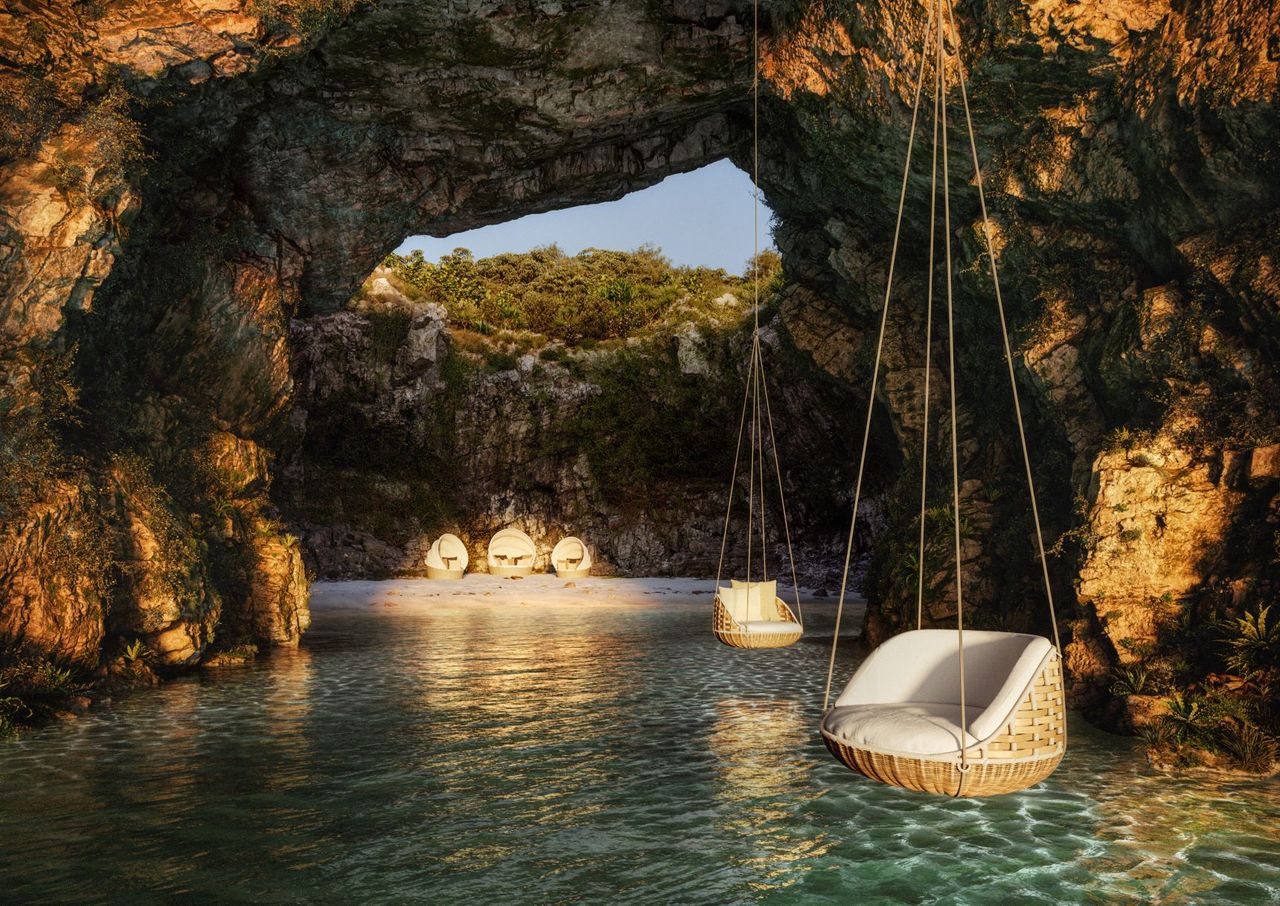 Two wicker seats suspended above water with a seating area in the background