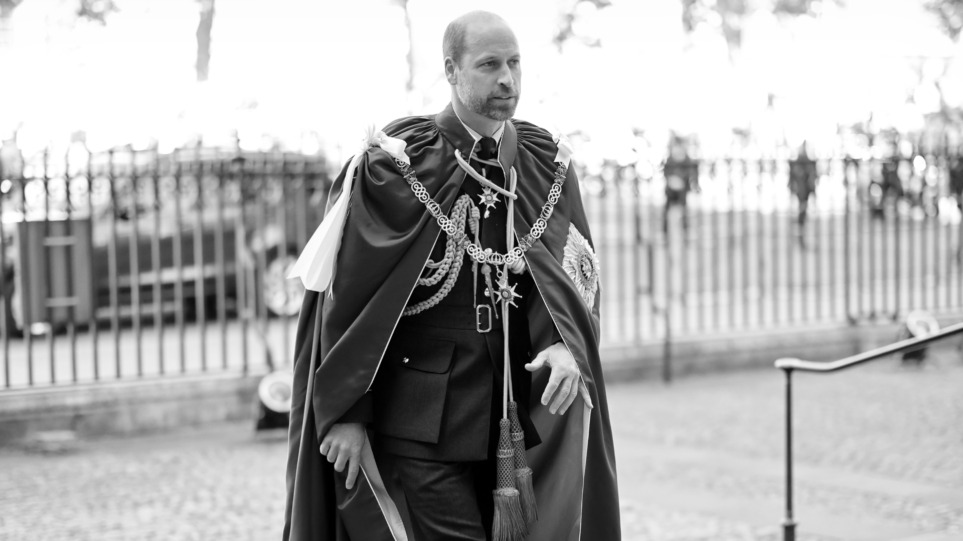 A black and white picture of Prince William wearing a robe with medals