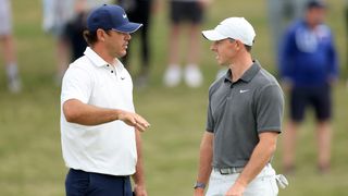 Brooks Koepka talks to Rory McIlroy at the US Open