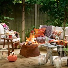 Fire pit on decking with garden seating