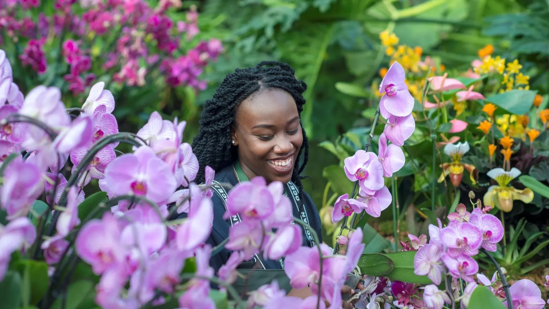 Kew Gardens Orchid Festival - woman standing amongst orchids 