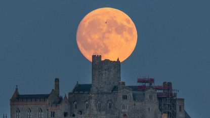 The July Full Moon rises behind St Michael's Mount in Penzance, July 28, 2026