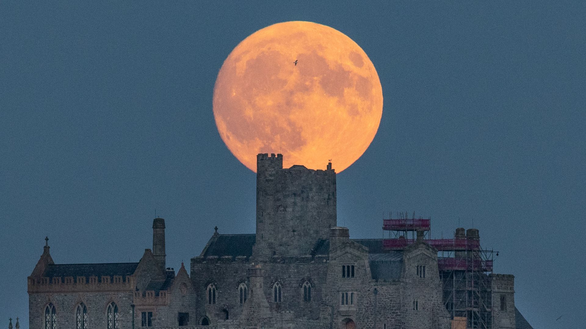 The July Full Moon rises behind St Michael's Mount in Penzance, July 28, 2026
