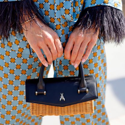 Annika Gassner, wearing a blue patterned suit by Zara and a black and beige bag by Patrizia Pepe, seen on July 9, 2024 in Palma de Mallorca, Spain