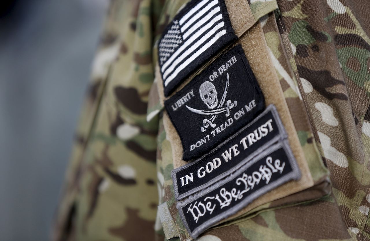 Patches on the sleeve of a militia man&amp;#039;s jacket.