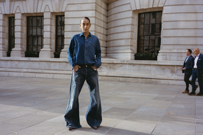 A model wears ELV Denim jeans and a shirt