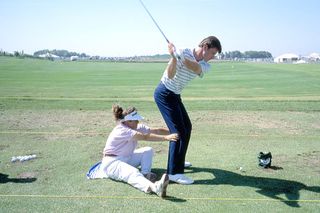 Caddiie Fanny Sunesson helps Nick Faldo on one of his training techniques