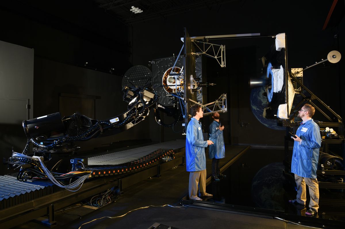 Northrop Grumman engineers conducting a docking test on the ground to check technology for the MEV-1 satellite servicing mission.