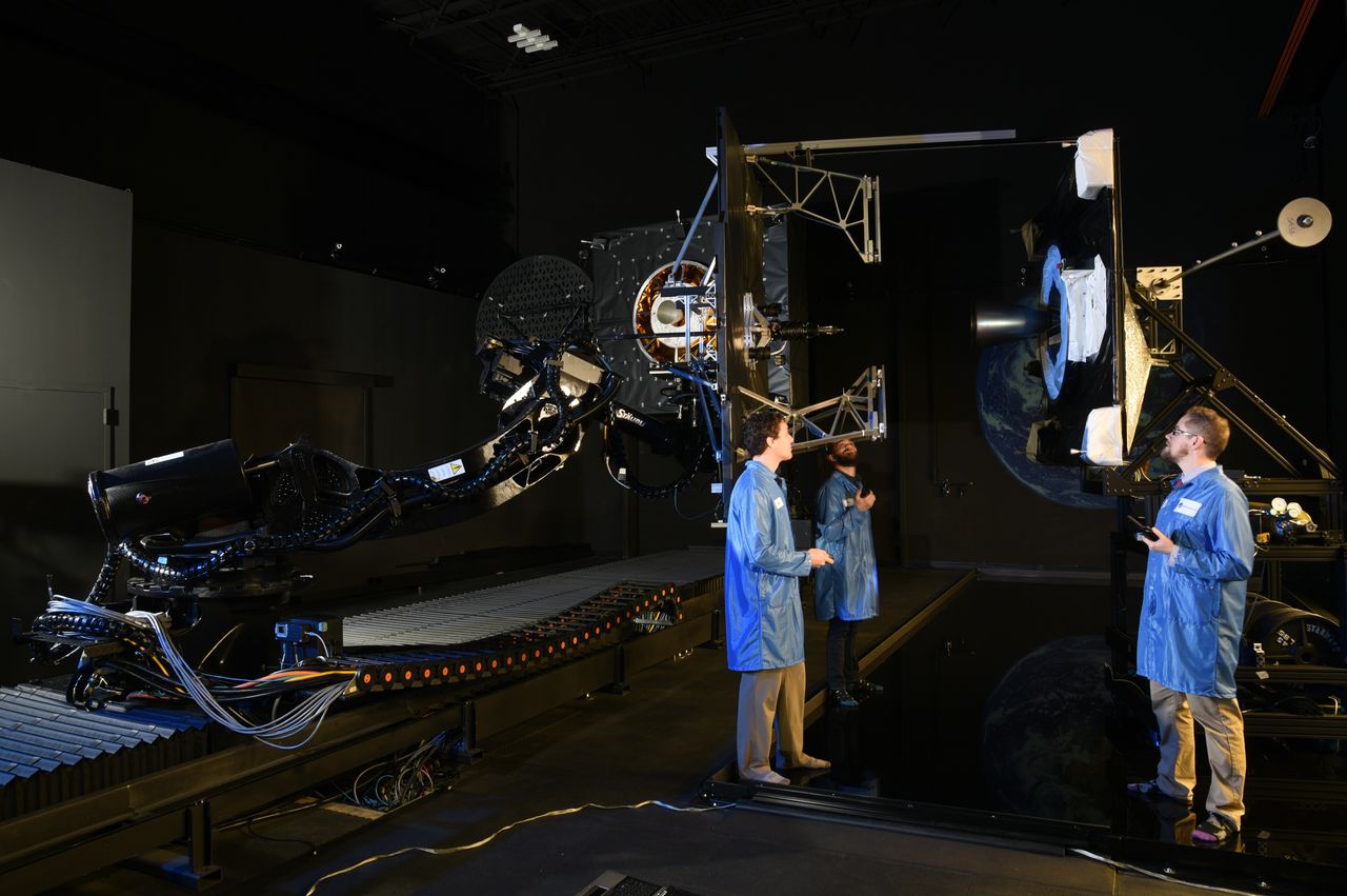 Northrop Grumman engineers conducting a docking test on the ground to check technology for the MEV-1 satellite servicing mission.