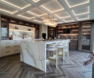 Wood and marble kitchen with decorative moldings on the cabinetry