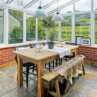 conservatory with white frame window and red brick wall