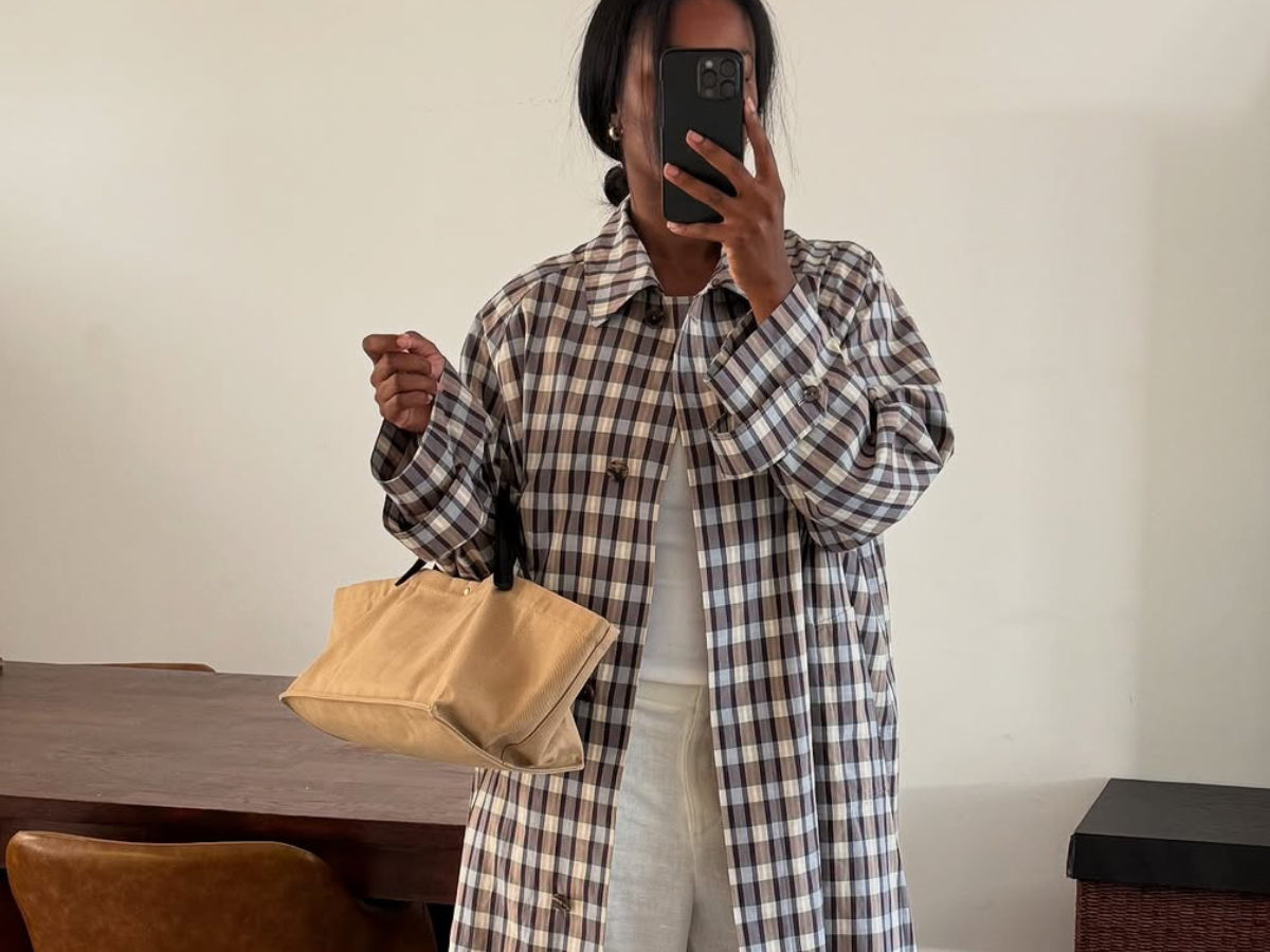Woman wearing plaid jacket trend fall 2025.