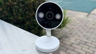 Tapo C120 security camera sits on metal surface
