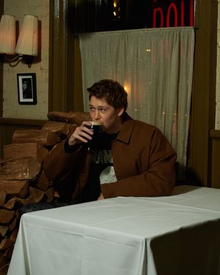 JOE ALWYN drinks pint of guinness in JW Anderson