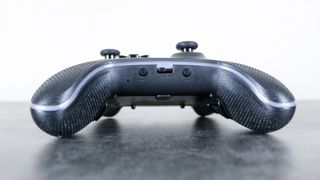 A close up shot of the front underside of the PowerA OPS v3 Pro controller showing the toggle to switch between wireless modes